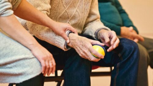 old man holding ball